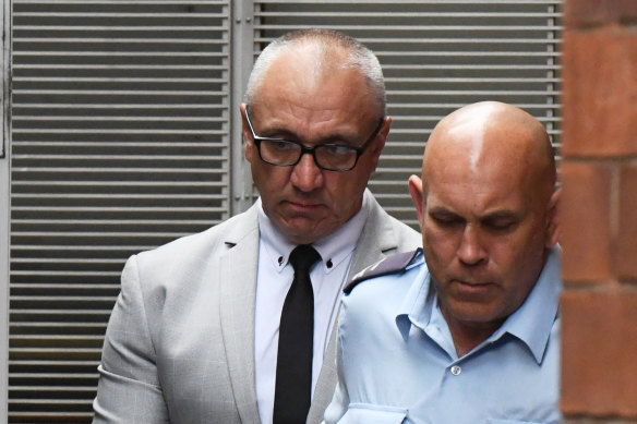 Michael Meakin, left, is taken from the NSW Supreme Court in Sydney on Friday.