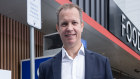 Ampol chief executive Matt Halliday with electric vehicle chargers at the company’s petrol and EV charging station in Alexandria, Sydney.  Photo Louie Douvis .