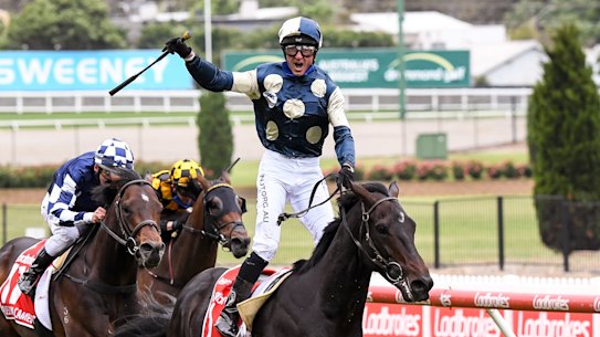 Glen Boss stands in the irons as Sir Dragonet crosses the line to win the Cox Plate.