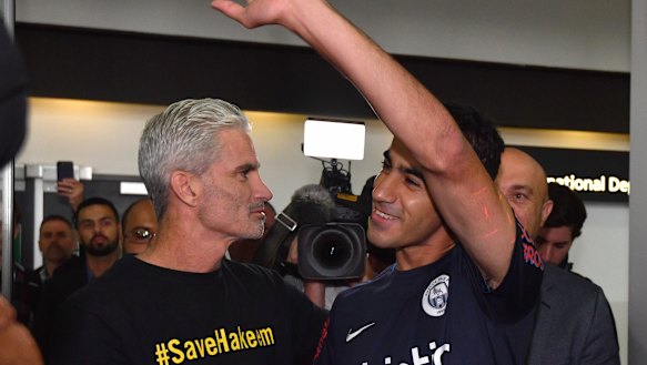 A jubilant Hakeem al-Araibi walks out of Melbourne Airport alongside former Socceroos captain Craig Foster.