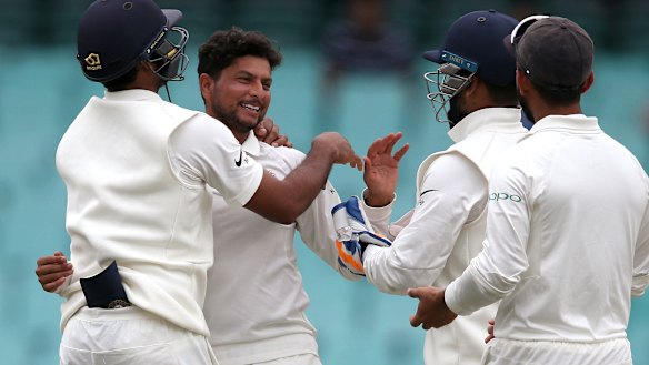 The Indian team celebrates another Australian wicket in Sydney.