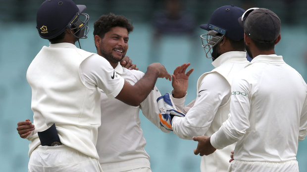 The Indian team celebrates another Australian wicket in Sydney.
