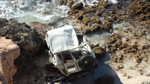 The roof of the white Toyota LandCruiser caved in on impact after it plunged 20 metres off the cliff.