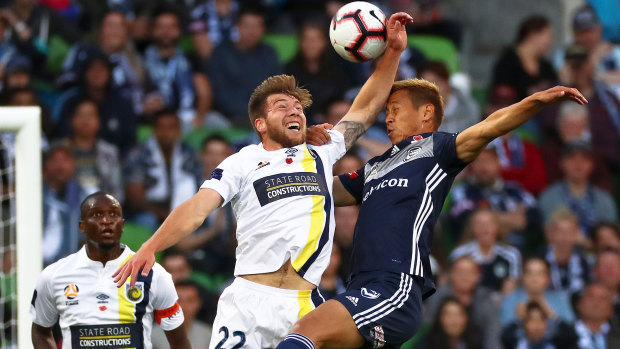 All in: Jacob Melling of the Mariners clashes with Keisuke Honda.