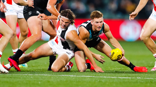 Winning ways: Hunter Clark scrambles with Port's Kane Farrell during St Kilda's upset round 8 victory at Adelaide Oval.