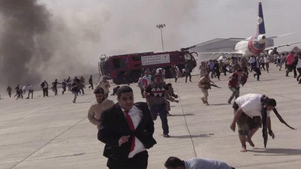 People run after an explosion at the airport in Aden, Yemen, shortly after a plane carrying the newly formed cabinet landed.