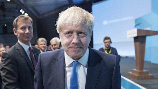 Boris Johnson, leader of the Conservative Party, right, makes his way to the stage during the announcement of the winner of the Conservative Party.
