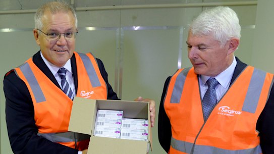 Prime Minister Scott Morrison holds a box of AstraZeneca vaccines at the CSL factory in Melbourne last month.