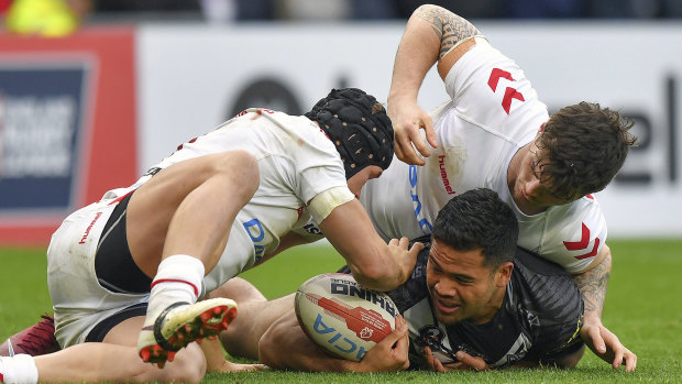 New Zealand's Esan Marsters is tackled by England's Jonny Lomax and John Bateman.