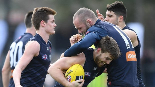 Jack Viney and Max Gawn get close and personal.
