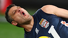 Brendan Fevola reacts after hurting his leg.