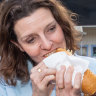 Allegra Spender, the new MP for Wentworth, eating a ‘democracy sausage’ at Double Bay on Saturday.