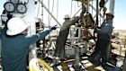 Workers on a Santos drilling rig in the Cooper Basin in 2003. Some of the company’s older infrastructure is being scrapped, leaving it with a multi-billion dollar clean-up fee.