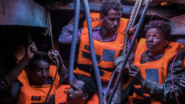 Sub-Saharan refugees and migrants, mostly from Eritrea, wait to be rescued by aid workers of Spanish NGO Proactiva Open Arms, in the lower deck of a wooden boat as they were trying to leave the Libyan coast and reach Europe last year.