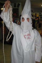 A soldier dressed in a Ku Klux Klan outfit at a party at the soldiers’ bar, the Fat Ladies Arms, in Afghanistan.