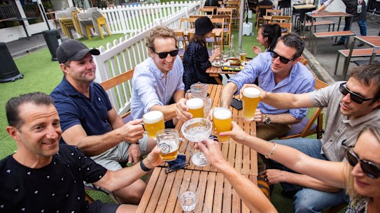 A group of friends gather to celebrate the easing of restrictions in Melbourne on Friday.