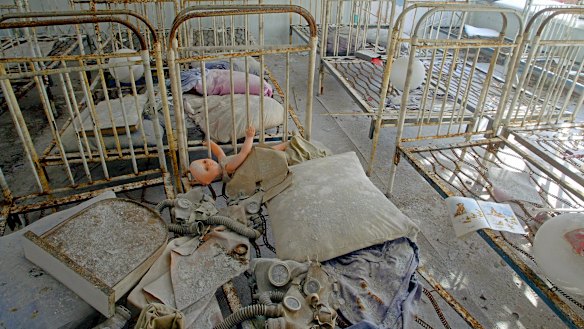 Children's toys and gas masks, covered by radioactive dust, on beds in an abandoned kindergarten in the ghost town of Pripyat, which was built nearly a mile from the Chernobyl nuclear plant, to house workers. 