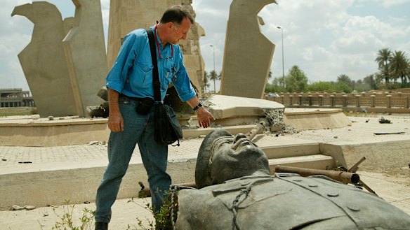 Paul McGeough looks down at one of the many felled Saddam Hussein statues in Baghdad during the 2003 invasion.