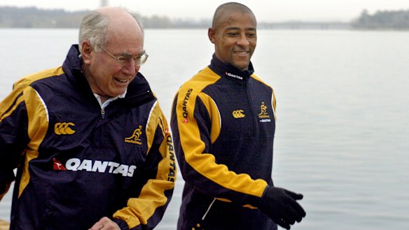 Former Wallabies captain George Gregan (right) joins then-prime minister John Howard on his early morning walk in Canberra in 2006.