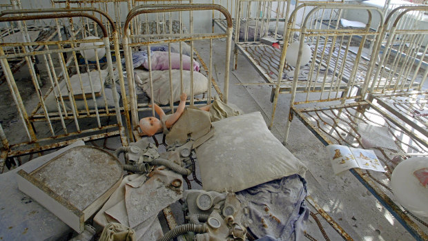 Children's toys and gas masks, covered by radioactive dust, on beds in an abandoned kindergarten in the ghost town of Pripyat, which was built nearly a mile from the Chernobyl nuclear plant, to house workers. 