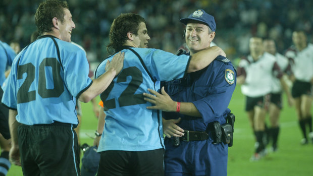 Joaquin Pastore, now Uruguay's attack coach, celebrates with a NSW Police officer after beating Georgia at the 2003 World Cup. 