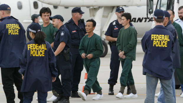 Crew members of Pong Su being escorted by AFP 