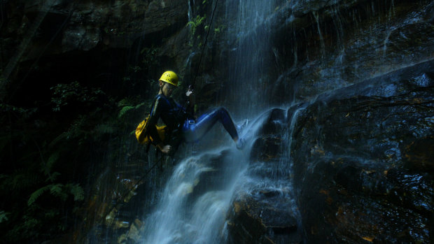 A tourist abseils down a waterfall in the Empress Falls Canyon in the Blue Mountains. 
