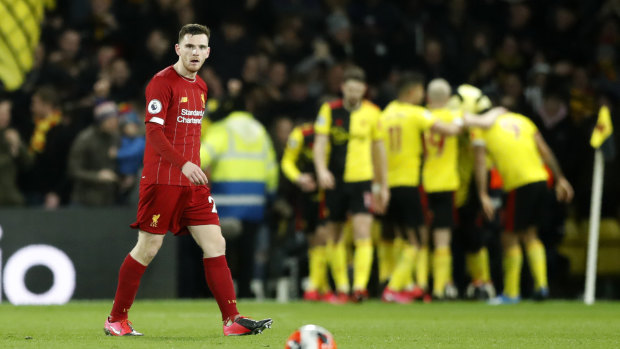 Liverpool's Andrew Robertson reacts after Watford's Troy Deeney scores his side's third goal at Vicarage Road.