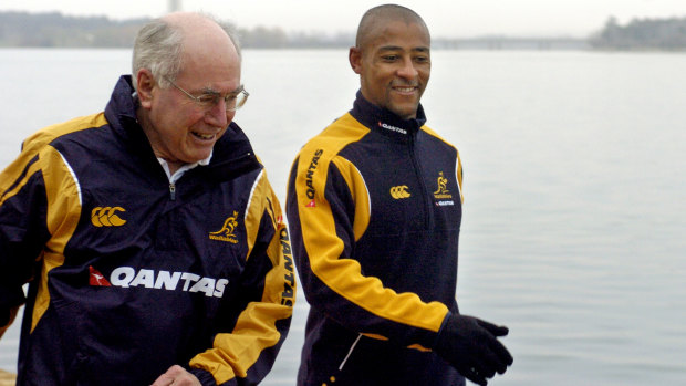 Former Wallabies captain George Gregan (right) joins then-prime minister John Howard on his early morning walk in Canberra in 2006.