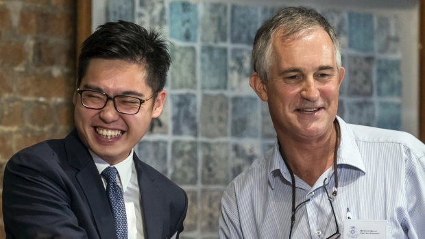 The Financial Times Asia news editor, Victor Mallet, right, shakes hands with Andy Chan, founder of the Hong Kong National Party, at the Foreign Correspondents Club in Hong Kong. 