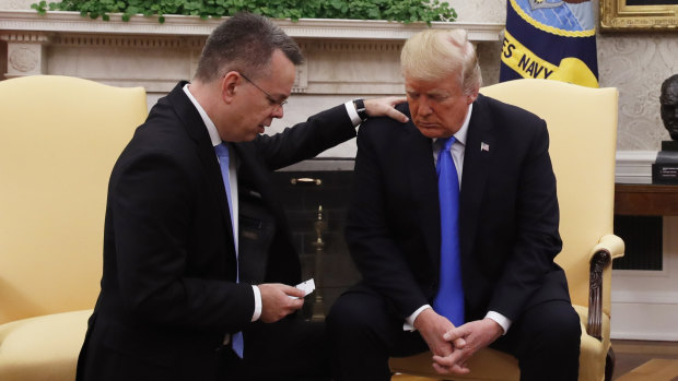 US President Donald Trump prays with American pastor Andrew Brunson in the Oval Office of the White House in 2018.