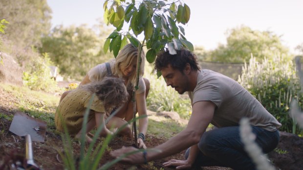Damon Gameau plants a tree with his daughter and wife.