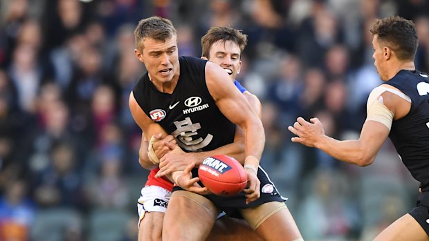 Bions try in vain to stop Blues star Patrick Cripps, who kicked four goals at Marvel Stadium.