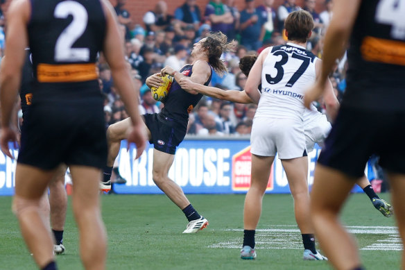 Nat Fyfe of the Dockers is taken high by Lachie Fogarty of the Blues.