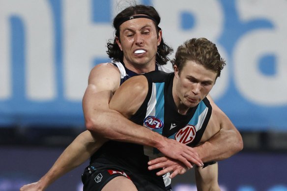 Geelong’s Jack Henry wraps Port Adelaide’s Xavier Duursma in a tackle on Saturday night.