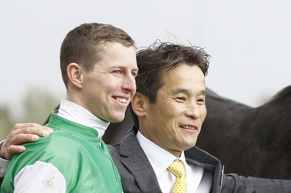Trainer Hisashi Shimizu (centre) says he will trust jockey Damian Lane's tactics for Tuesday's Melbourne Cup.