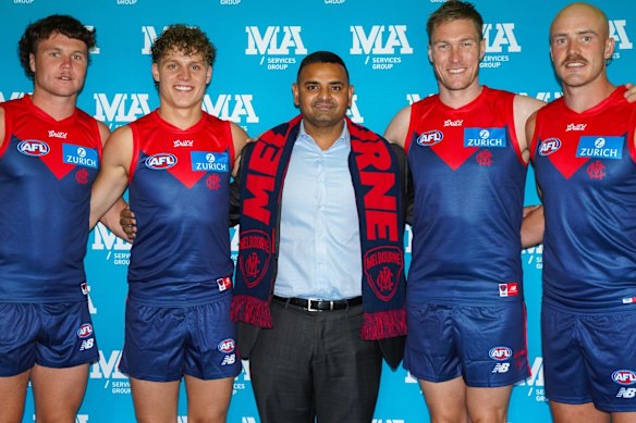 MA Services Group’s Micky Ahuja with Melbourne Demons players.