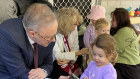 Prime Minister Anthony Albanese interacts with a child at the Bardon Early Learning Centre. 