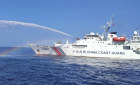 In this photo provided by the Philippine Coast Guard, a Chinese Coast Guard ship, right, uses its water cannons on a Philippine Bureau of Fisheries and Aquatic Resources vessel, not shown.