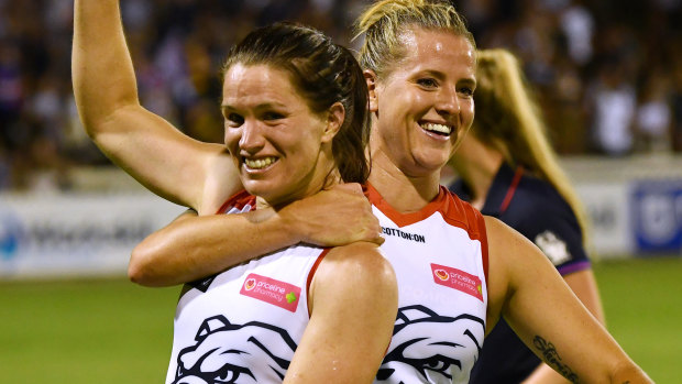 Fans' best friends: Emma Mackie (left) and Hannah Scott of the Western Bulldogs celebrate their round one win over the Crows at Norwood Oval in Adelaide.