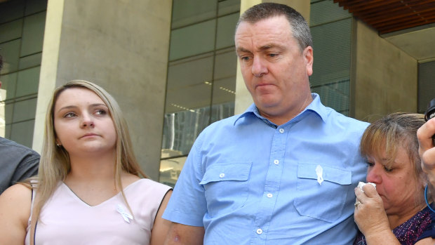 Patricia Riggs' brother Mark Knowles, of Canberra, with his wife Tracy and their daughter Tracy outside the court in Brisbane on Wednesday.