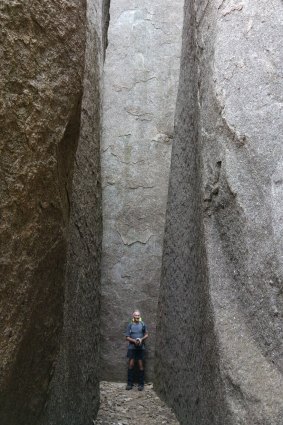 John Evans is dwarfed by Namadgi National Park's Split Rock.