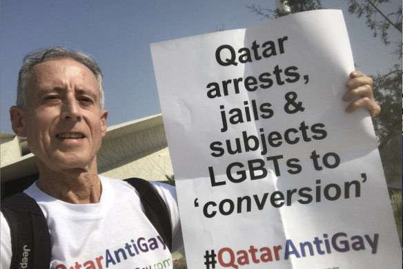 Australian-born gay rights campaigner Peter Tatchell holds up a sign protesting against Qatar’s discrimination against the LGBT community in Qatar.