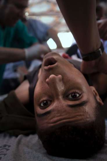 An injured Palestinian youth receives treatment in a fie   ld clinic after being shot by Israeli troops during a protest in the Gaza Strip in July.