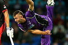 Aaron Summers, right, bowling for the Hobart Hurricanes in 2017. 