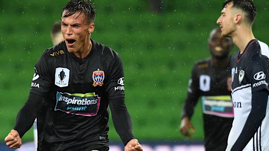 Deciding strike: Newcastle's Patrick Langois scores a late winner against Victory at AAMI Park in Melbourne.