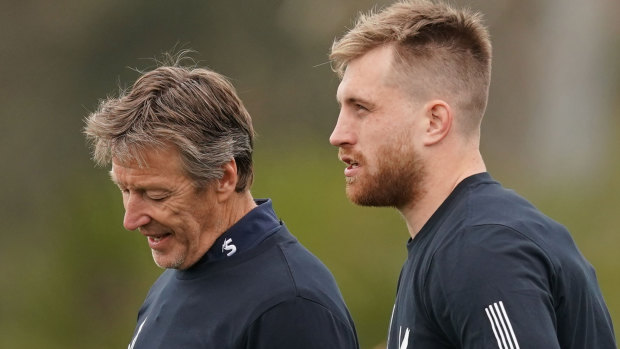 Storm coach Craig Bellamy (left) talks to Cameron Munster (right) during Tuesday training at Gosch's Paddock. 