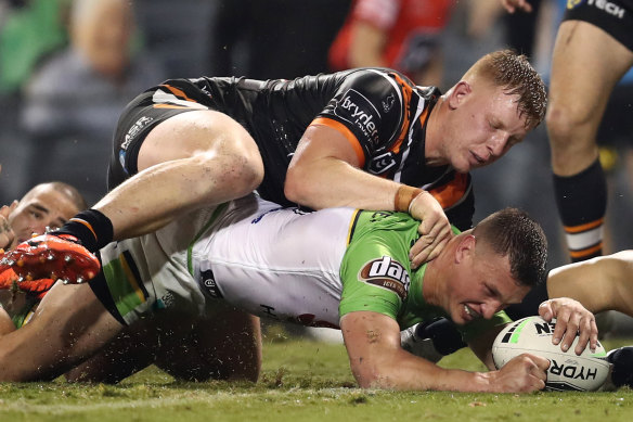 Jack Wighton scores a try despite the best efforts of Alex Seyfarth at Campbelltown Stadium.