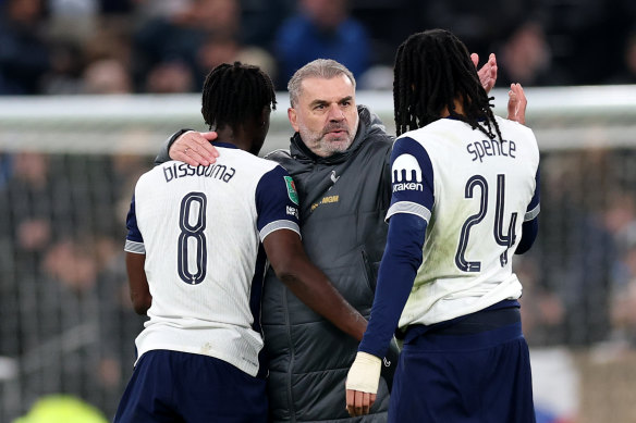 Ange Postecoglou celebrates with his players after their Carabao Cup first-leg win over Liverpool.