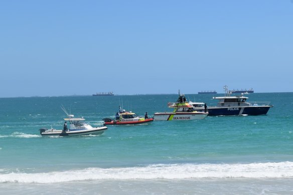 Emergency services search the water for a man feared taken by a shark at Port Beach in North Fremantle.